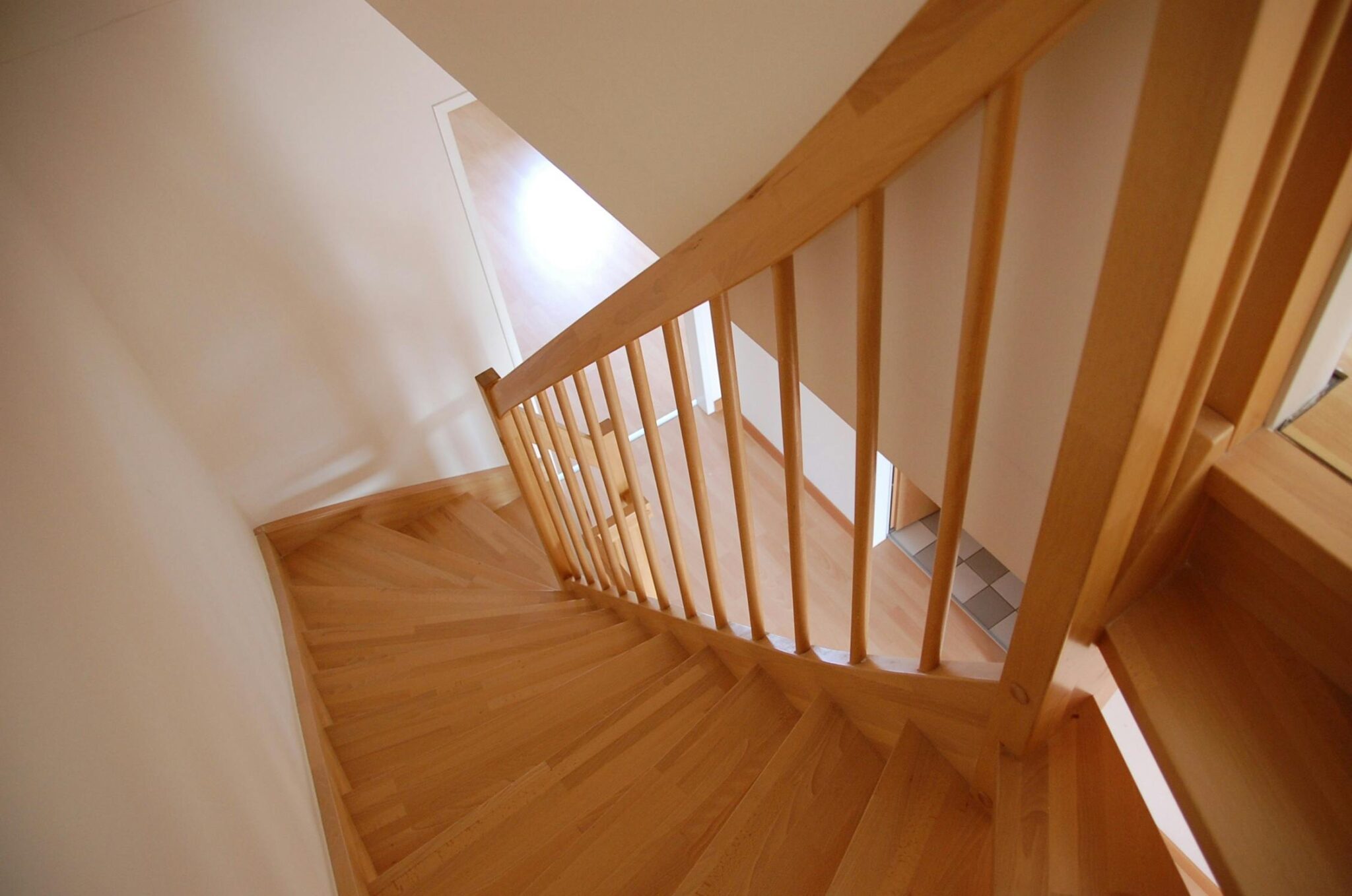 Wooden staircase with warm tones inside a minimalist home interior.