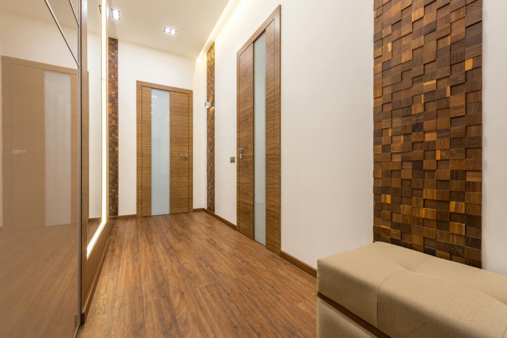 Contemporary hallway featuring wooden doors, parquet flooring, and stylish wall design.